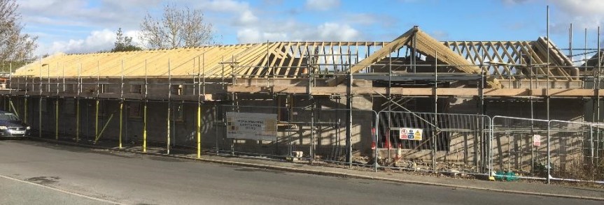 Partially built village hall with the roof trusses now added
