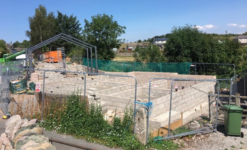 The first brickwork is laid for the new village hall